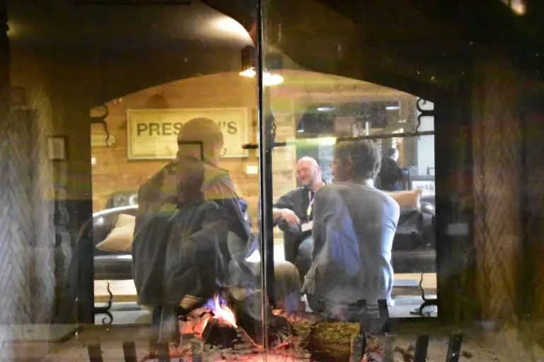 Educators sitting by the fireplace in discussion