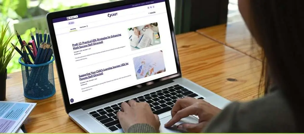 Person on a laptop reading through course offerings on the CAST website
